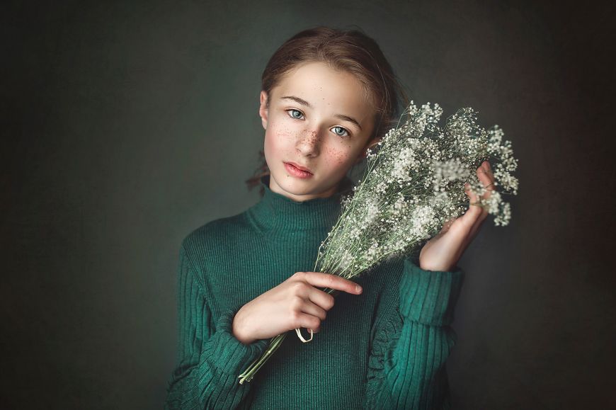 Portrait studio de cette jeune fille dont le visage est mis en valeur par ces jolies fleurs. Photo @Emilie Postec Barralier  Trouver votre photographe sur www.regardauteur.com    #enfant #fille #vert #accesoire #fleurs #simplicité #portrait #studio #shooting #photographe #photographie #regardauteur 